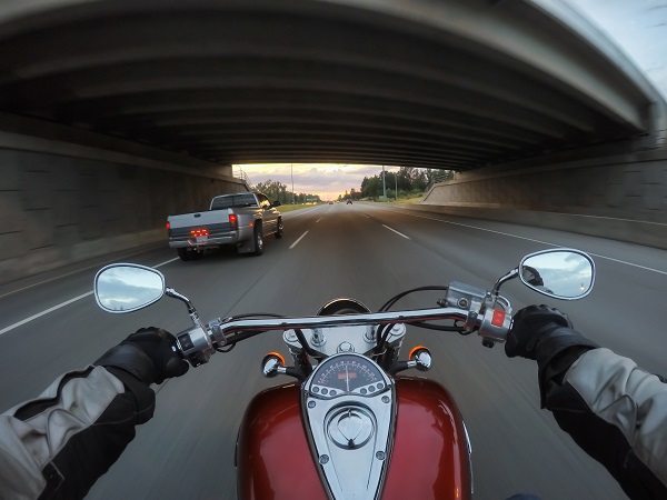 Riding a motorcycle during a vibrant sunset.